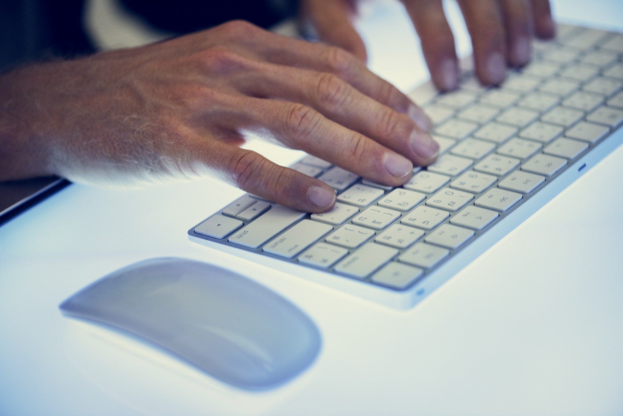 Hands typing on a keyboard